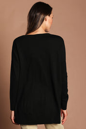 Model Madeline wearing size S of The High Low V Neck Jumper in colour Black (Black), from the back