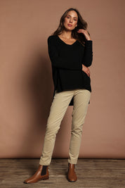 Model Madeline wearing size S of The High Low V Neck Jumper in colour Black (Black), from the front, showing the whole outfit