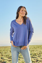 Model Amanda wearing size S of The High Low V Neck Jumper in colour Dustyblue (Blue), from the front, showing the whole outfit