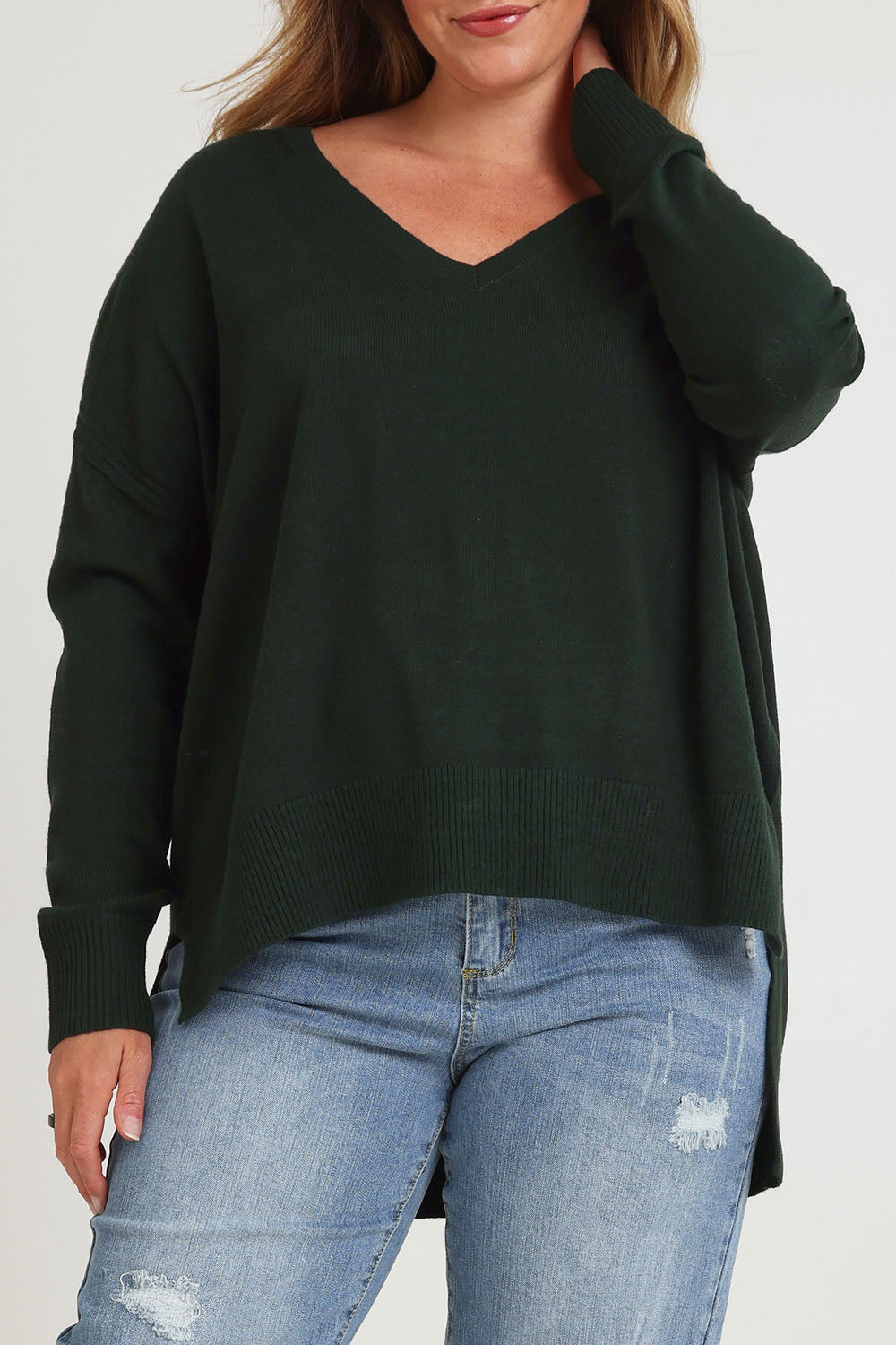 Model Chanel wearing size XL of The High Low V Neck Jumper in colour Forest (Green), from the front, cropped image