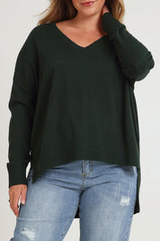 Model Chanel wearing size XL of The High Low V Neck Jumper in colour Forest (Green), from the front, cropped image