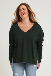 Model Chanel wearing size XL of The High Low V Neck Jumper in colour Forest (Green), from the front, cropped image