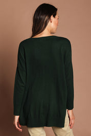 Model Madeline wearing size S of The High Low V Neck Jumper in colour Forest (Green), from the back