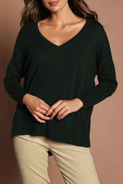 Model Madeline wearing size S of The High Low V Neck Jumper in colour Forest (Green), from the front, cropped image