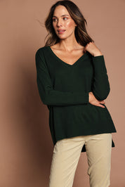 Model Madeline wearing size S of The High Low V Neck Jumper in colour Forest (Green), from the front, showing the whole outfit