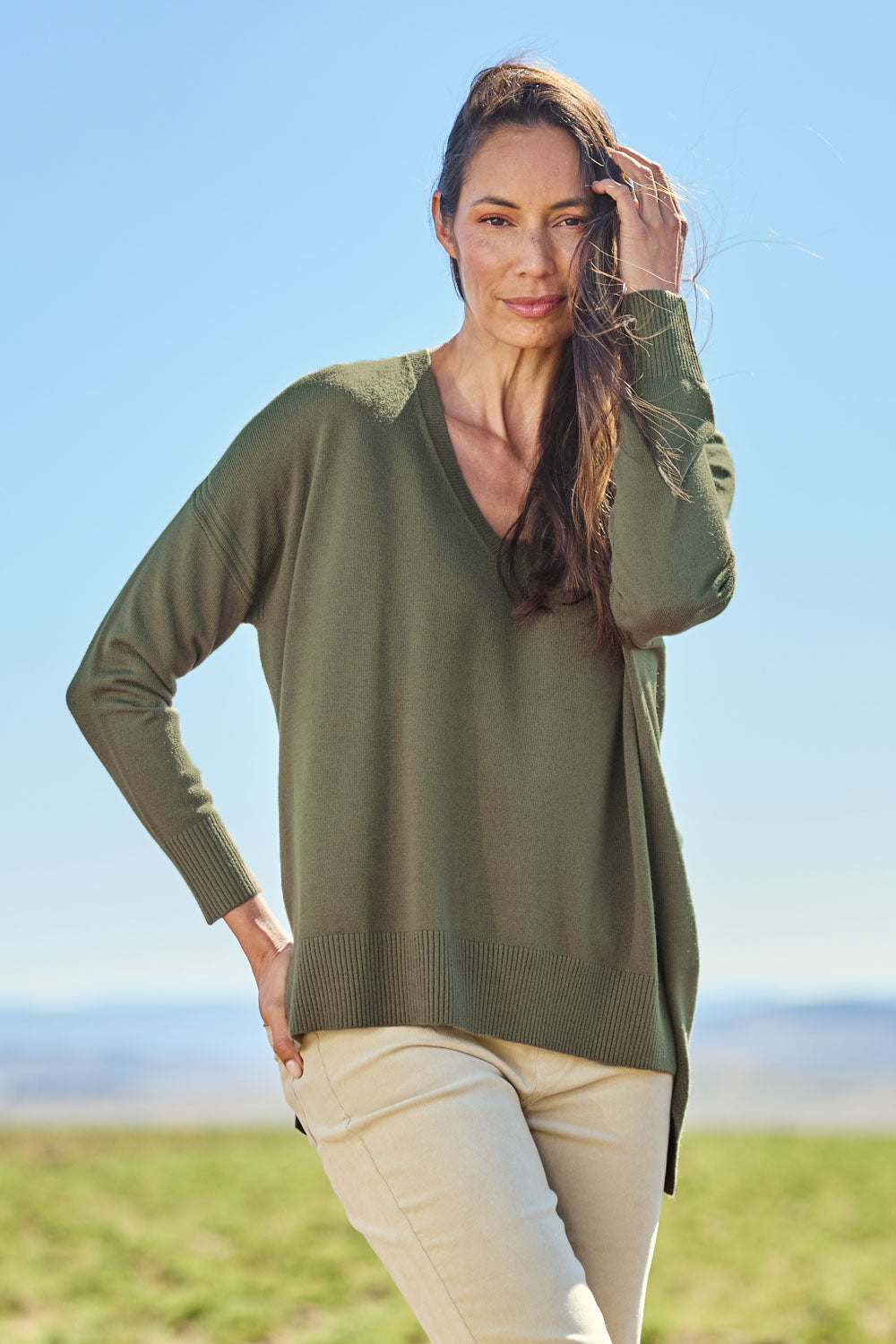 Model Amanda wearing size S of The High Low V Neck Jumper in colour Khaki (Green), from the front, showing the whole outfit