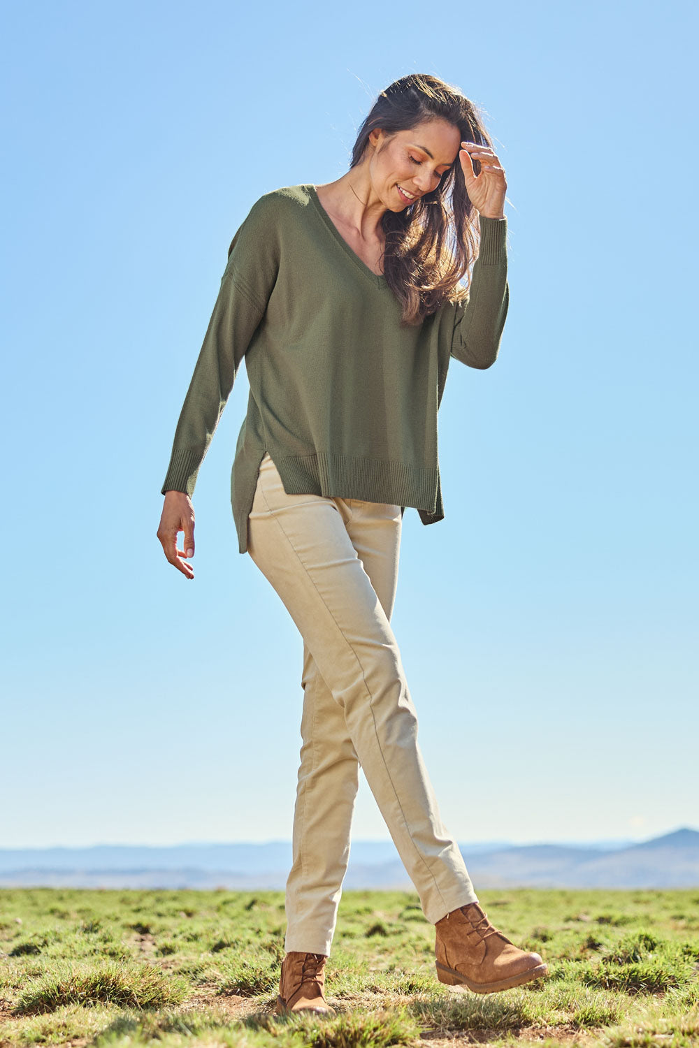 Model Amanda wearing size S of The High Low V Neck Jumper in colour Khaki (Green), from the front, showing the whole outfit