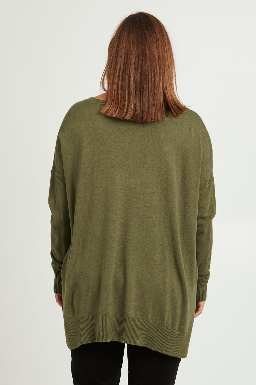Model Monique wearing size L of The High Low V Neck Jumper in colour Khaki (Green), from the back