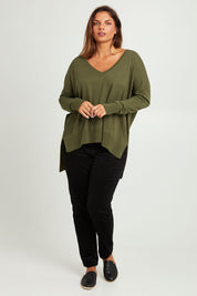 Model Monique wearing size L of The High Low V Neck Jumper in colour Khaki (Green), from the front, showing the whole outfit