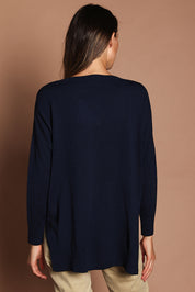 Model Madeline wearing size S of The High Low V Neck Jumper in colour Navy (Blue), from the back