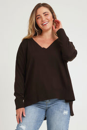 Model Chanel wearing size XL of The High Low V Neck Jumper in colour Sable, from the front, cropped image