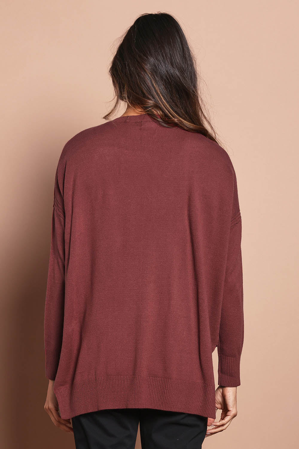 Model Amanda wearing size S of The High Low V Neck Jumper in colour Smokeyrose (Pink), from the back