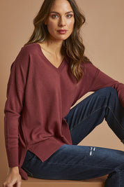 Model Madeline wearing size S of The High Low V Neck Jumper in colour Smokeyrose (Pink), from the front, showing the whole outfit