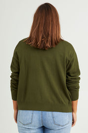 Model Monique wearing size L of The Soft Cropped Cardigan in colour Darkolive (Green), from the back