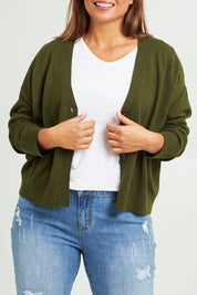 Model Monique wearing size L of The Soft Cropped Cardigan in colour Darkolive (Green), from the front, cropped image