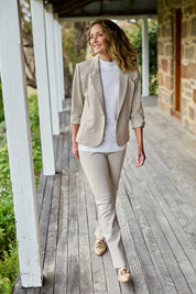Model Emma wearing size 10 of The Keepers Pull On Jacquard Pant in colour Tanivory, from the front, showing the whole outfit