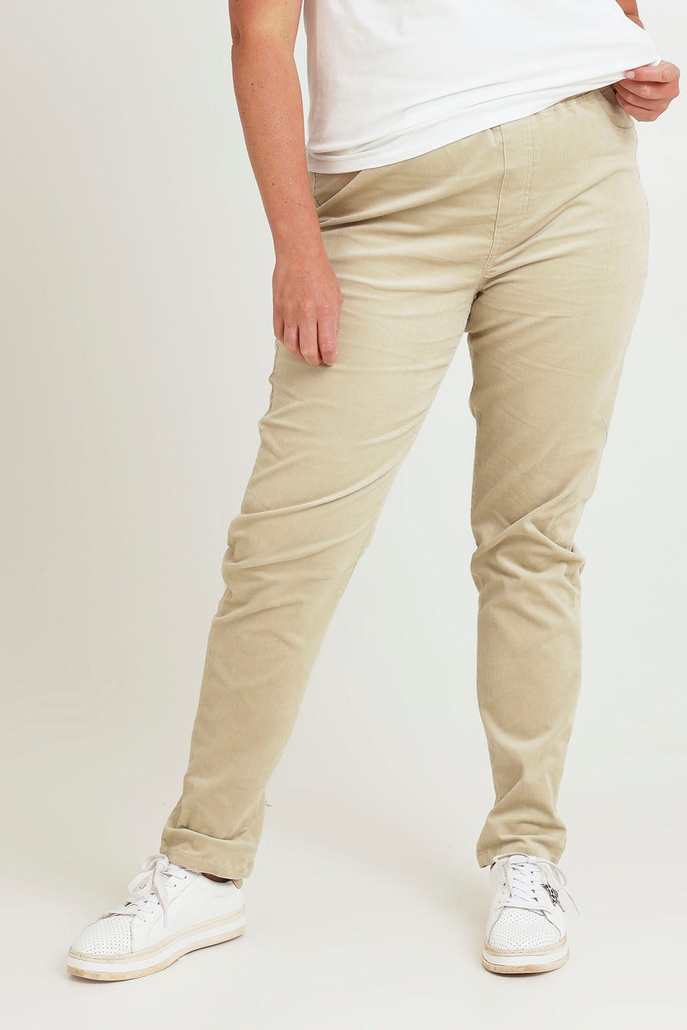 Model Chanel wearing size 16 of The Keepers Cord Pull On Pant in colour Almond, from the front, cropped image