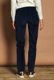 Model Madeline wearing size 10 of The Keepers Cord Pull On Pant in colour Darknavy (Blue), from the back