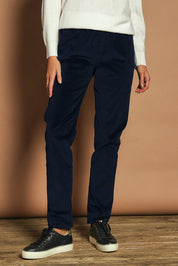 Model Madeline wearing size 10 of The Keepers Cord Pull On Pant in colour Darknavy (Blue), from the front, cropped image