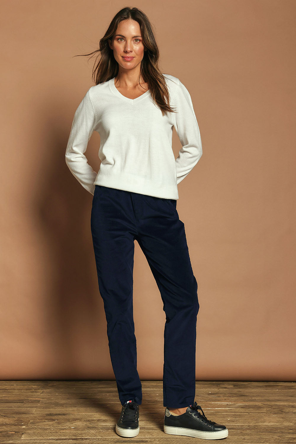 Model Madeline wearing size 10 of The Keepers Cord Pull On Pant in colour Darknavy (Blue), from the front, showing the whole outfit
