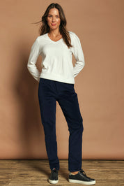 Model Madeline wearing size 10 of The Keepers Cord Pull On Pant in colour Darknavy (Blue), from the front, showing the whole outfit