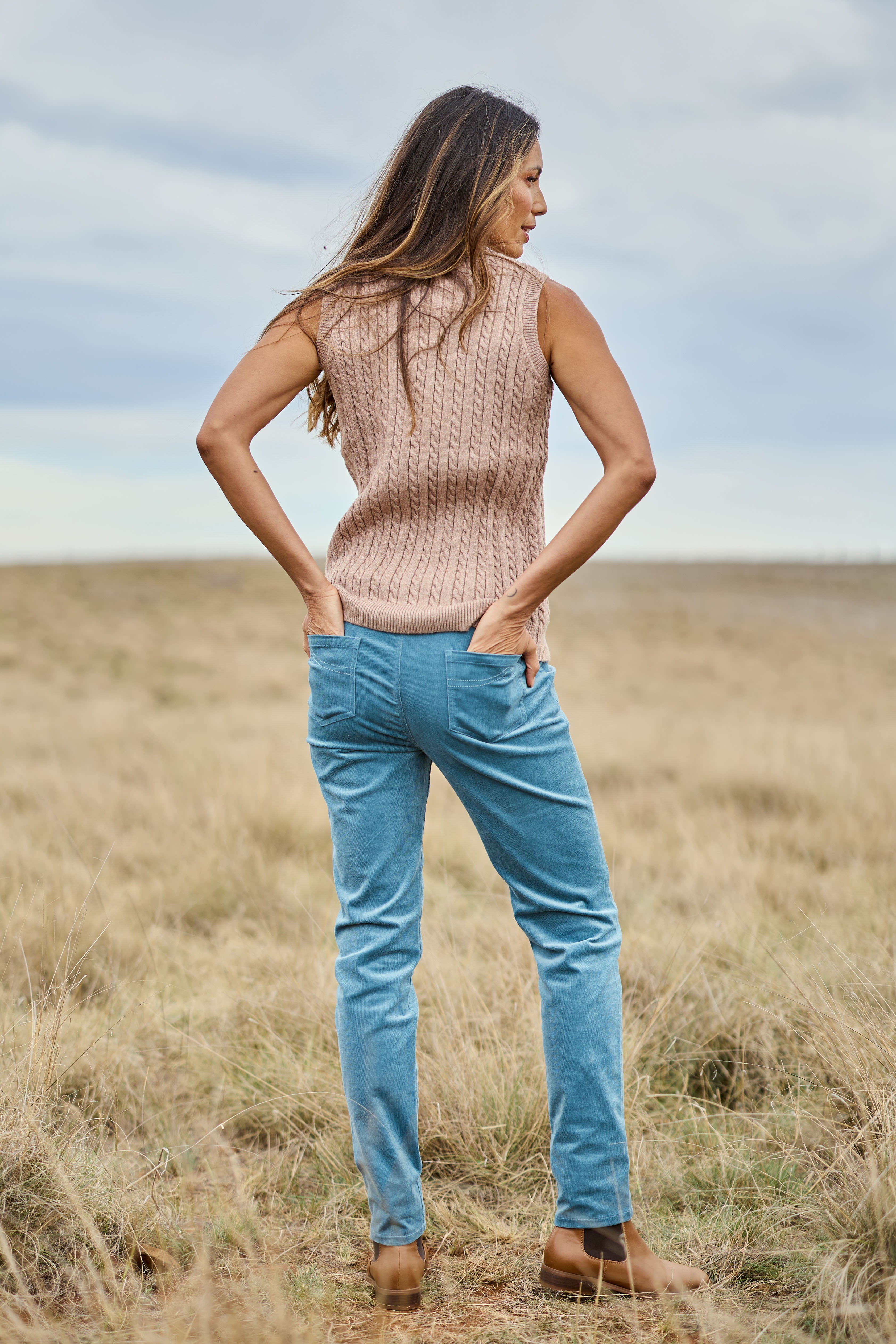 Model Amanda wearing size 10 of The Keepers Cord Pull On Pant in colour Denim (Blue), from the front, showing the whole outfit