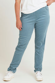 Model Chanel wearing size 16 of The Keepers Cord Pull On Pant in colour Denim (Blue), from the front, cropped image