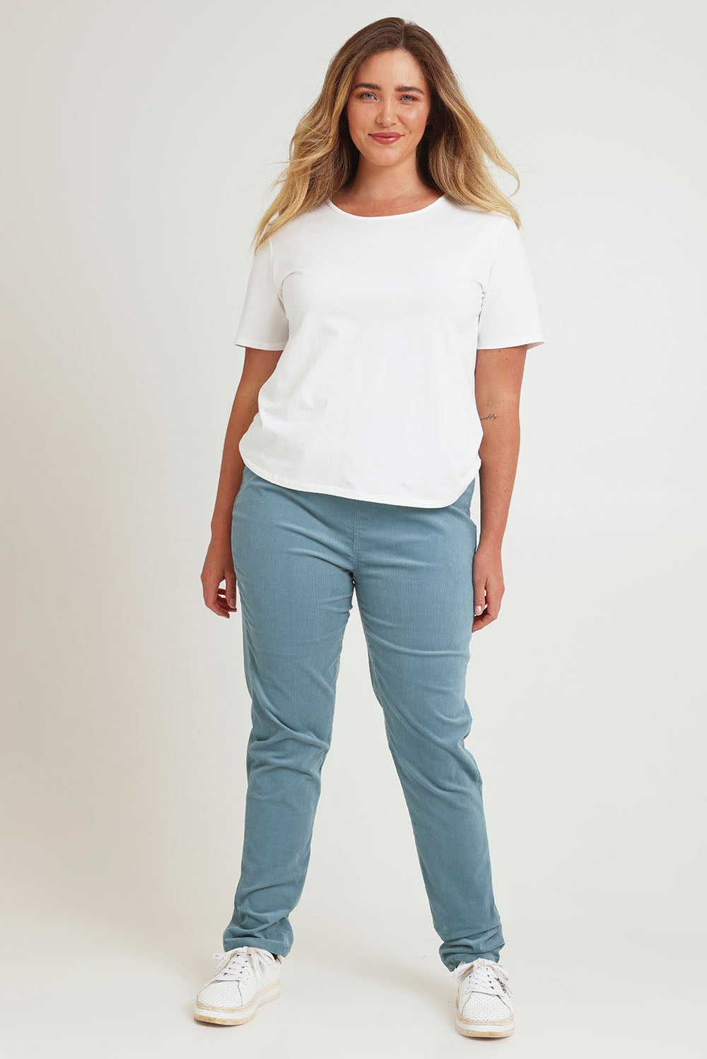 Model Chanel wearing size 16 of The Keepers Cord Pull On Pant in colour Denim (Blue), from the front, showing the whole outfit