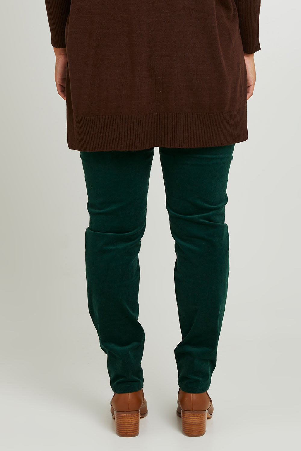 Model Monique wearing size 14 of The Keepers Cord Pull On Pant in colour Forest (Green), from the back