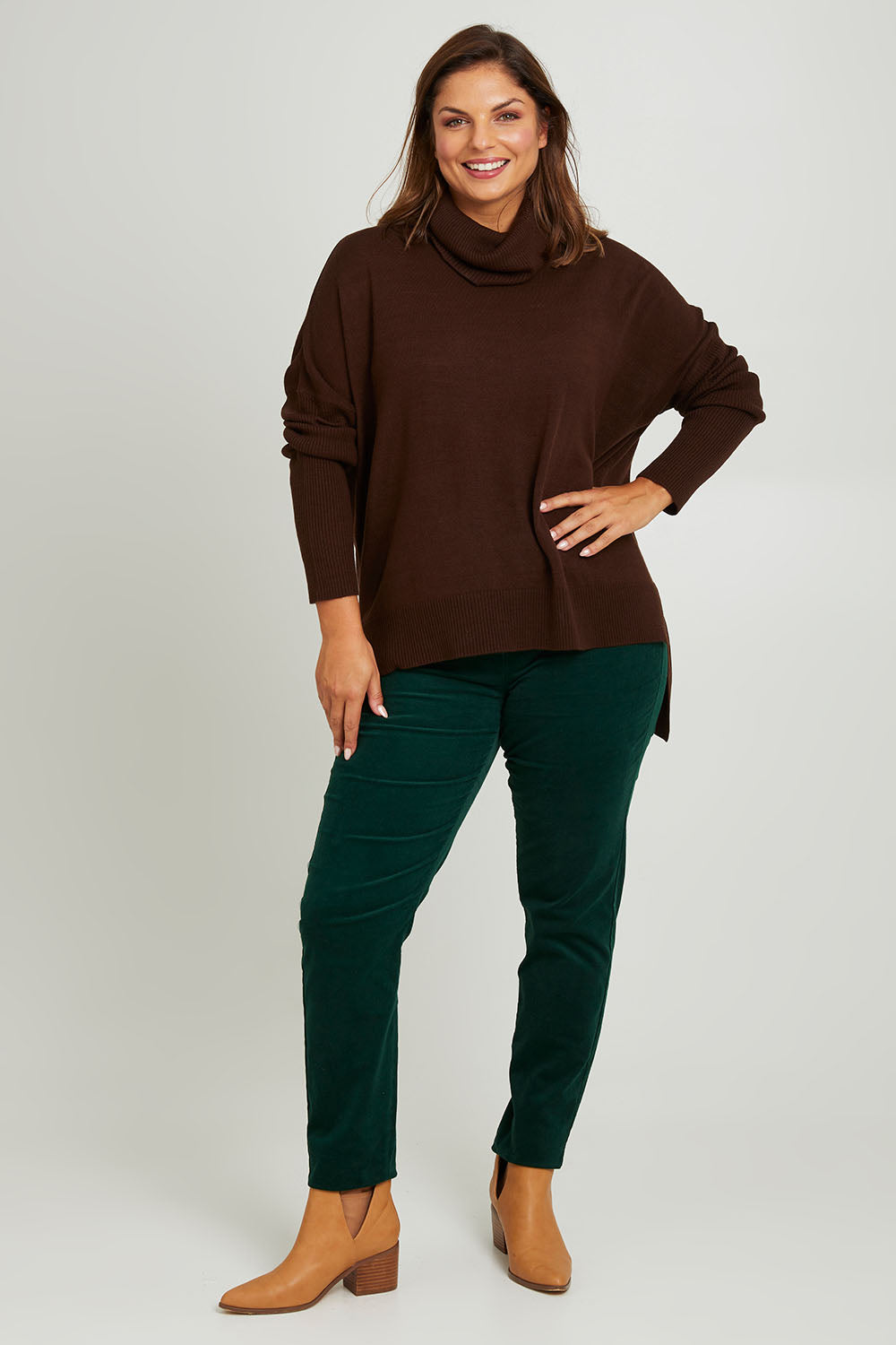 Model Monique wearing size 14 of The Keepers Cord Pull On Pant in colour Forest (Green), from the front, showing the whole outfit