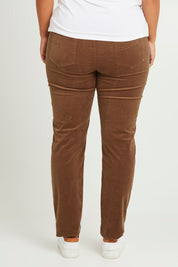 Model Monique wearing size 14 of The Keepers Cord Pull On Pant in colour Mushroom, from the back