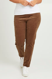 Model Monique wearing size 14 of The Keepers Cord Pull On Pant in colour Mushroom, from the front, cropped image