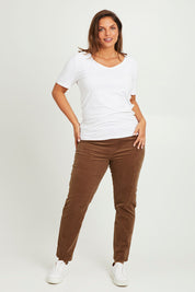 Model Monique wearing size 14 of The Keepers Cord Pull On Pant in colour Mushroom, from the front, showing the whole outfit