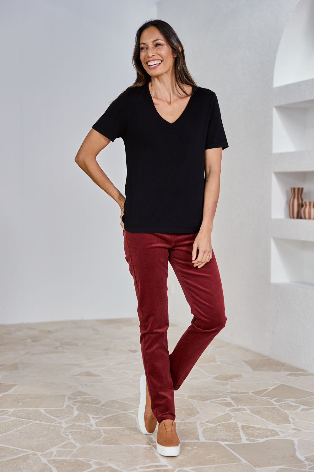 Model Amanda wearing size 10 of The Keepers Cord Pull On Pant in colour Shiraz (Red), from the front, showing the whole outfit
