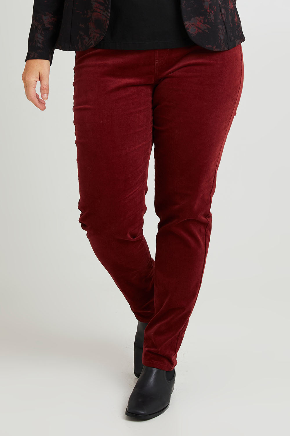 Model Laura wearing size 14 of The Keepers Cord Pull On Pant in colour Shiraz (Red), from the front, cropped image