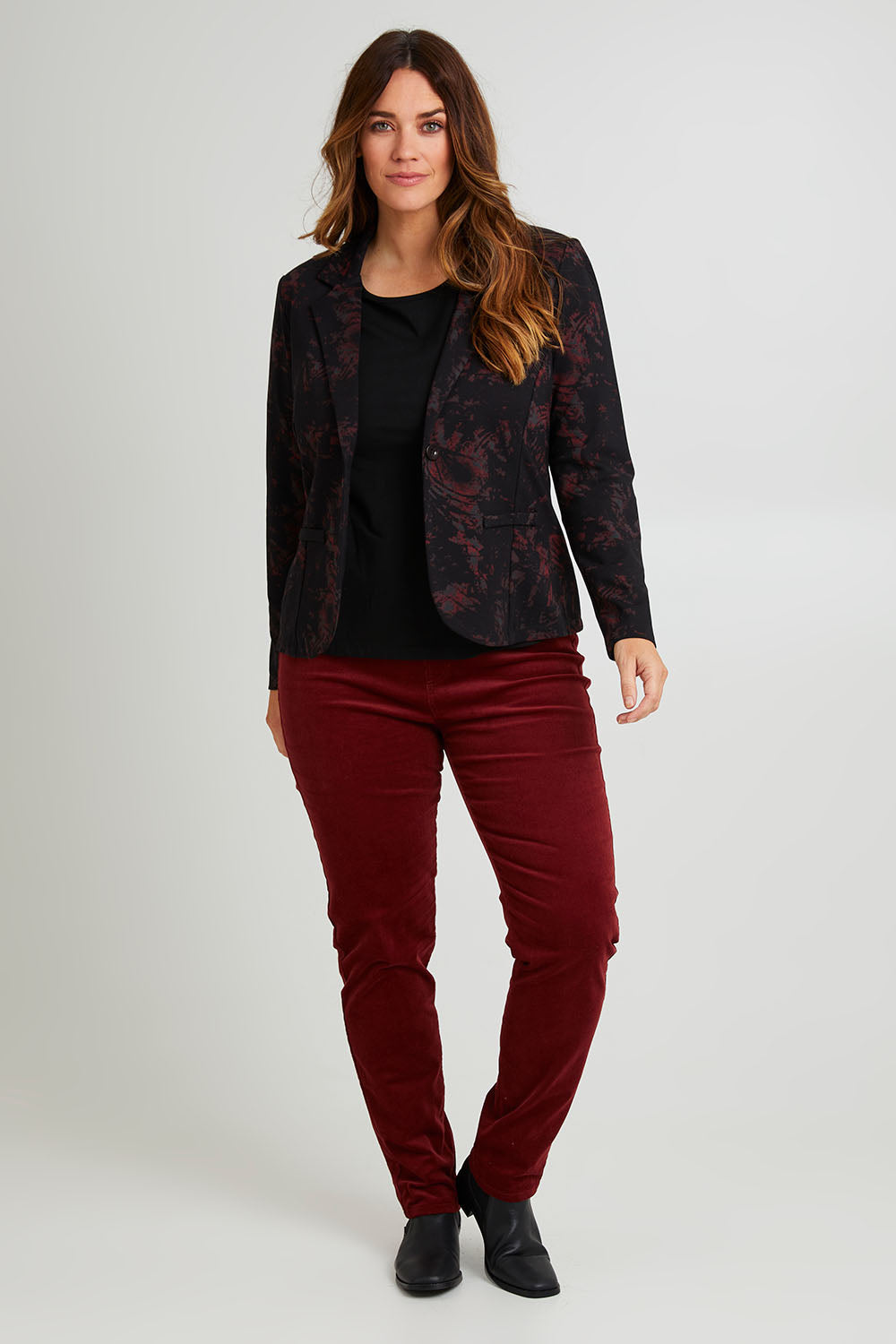 Model Laura wearing size 14 of The Keepers Cord Pull On Pant in colour Shiraz (Red), from the front, showing the whole outfit
