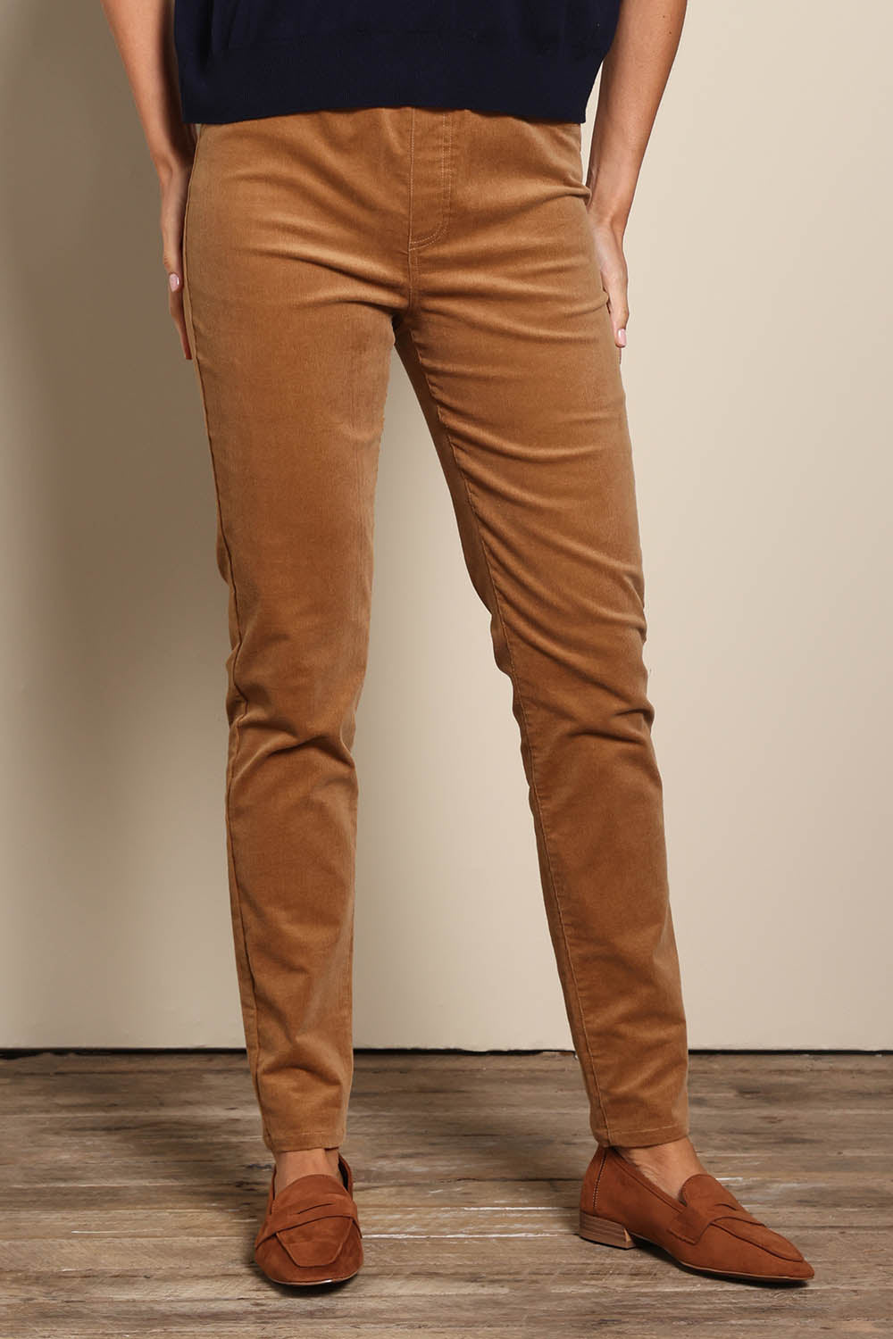 Model Amandam wearing size 10 of the The Keepers Cord Pull On Pant – Tan in colour Tan, in a cropped view