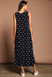 Model Madeline wearing size 10 of The Easy Wear Print Maxi Dress in colour Navyspot (Blue), from the back