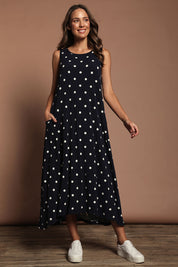 Model Madeline wearing size 10 of The Easy Wear Print Maxi Dress in colour Navyspot (Blue), from the front, showing the whole outfit