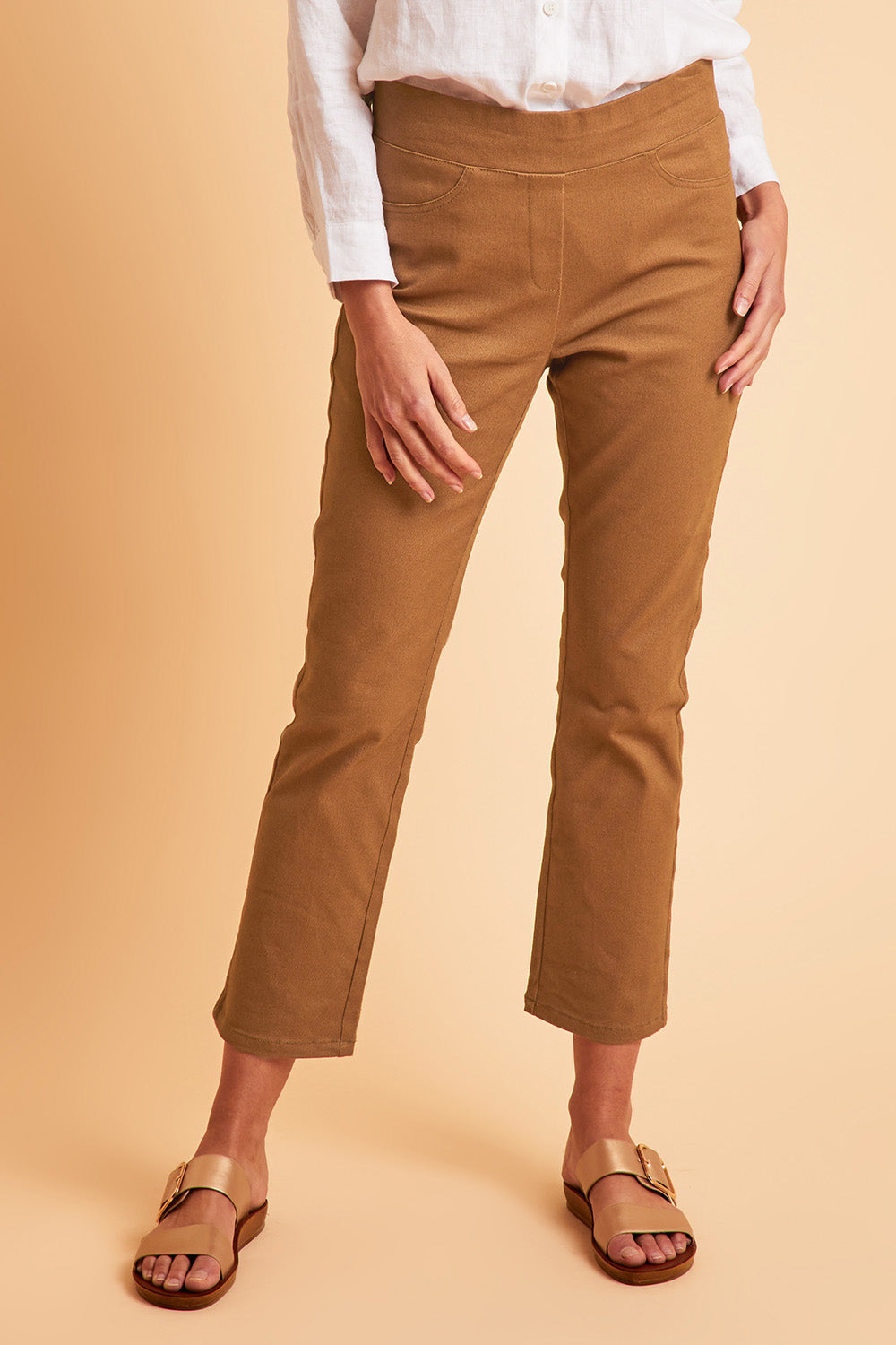 Model Madeline wearing size 10 of The 7/8 Pull On Coloured Jean in colour Tobacco, from the front, cropped image