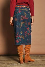 Model Madeline wearing size 10 of The 5 Pocket Printed Midi Skirt in colour Redfloral (Blue), from the back