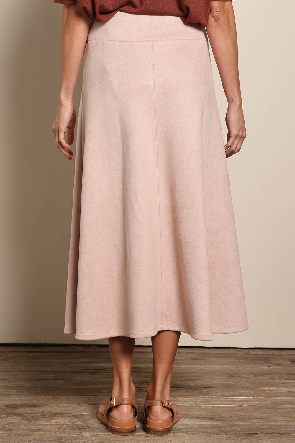 Model Amandam wearing size 10 of the The Luxe Faux Suede Skirt – Baci in colour Baci, from the back