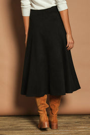 Model Madeline wearing size 10 of The Luxe Faux Suede Skirt in colour Black (Black), from the back