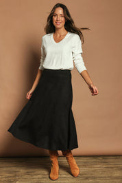 Model Madeline wearing size 10 of The Luxe Faux Suede Skirt in colour Black (Black), from the front, showing the whole outfit