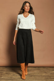 Model Madeline wearing size 10 of The Luxe Faux Suede Skirt in colour Black (Black), from the front, showing the whole outfit