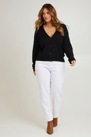 Model Laura wearing size L of The All Season Cropped Cardigan in colour Black (Black), from the front, showing the whole outfit