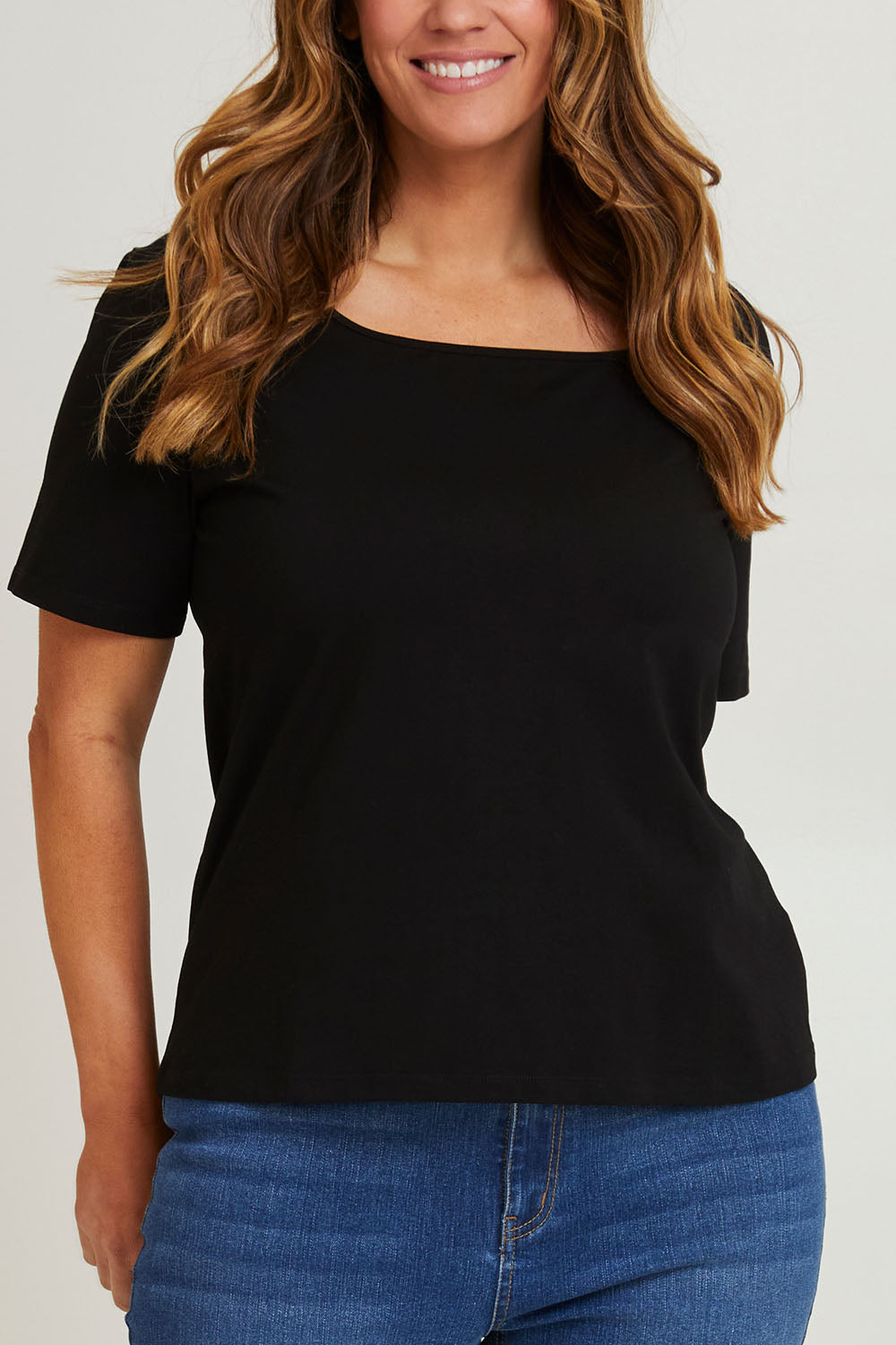 Model Laura wearing size 14 of The Keepers Square Neck Tee in colour Black (Black), from the front, cropped image