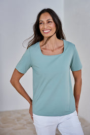 Model Amanda wearing size 10 of The Keepers Square Neck Tee in colour Sage (Green), from the front, showing the whole outfit