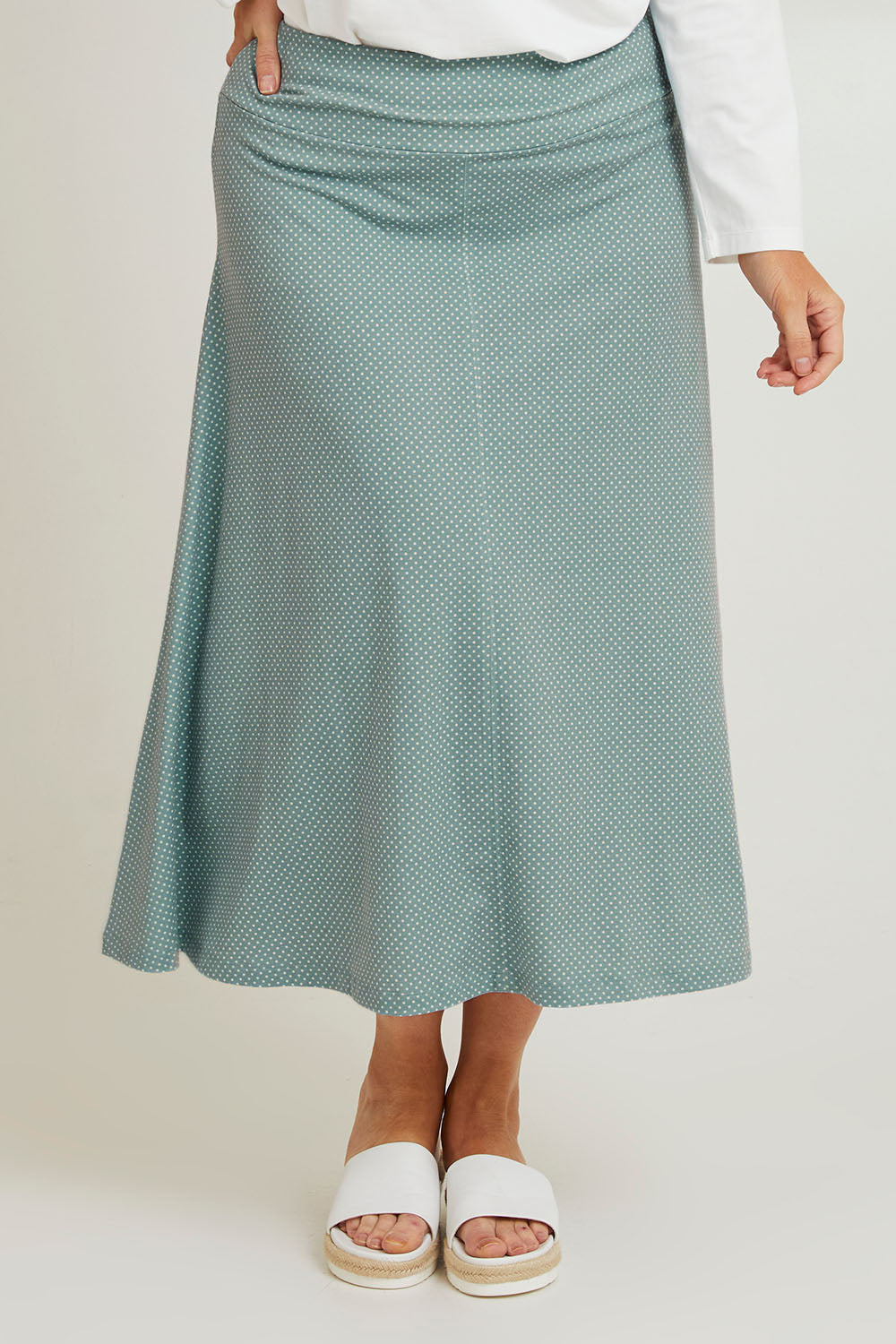 Model Laura wearing size 14 of The Bamboo Blend Print Fit & Flare Skirt in colour Aquaspot (Green), from the front, cropped image