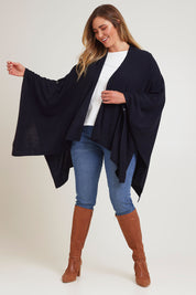 Model Chanel wearing The Every Season Poncho in colour Darknavy (Blue), from the front, showing the whole outfit